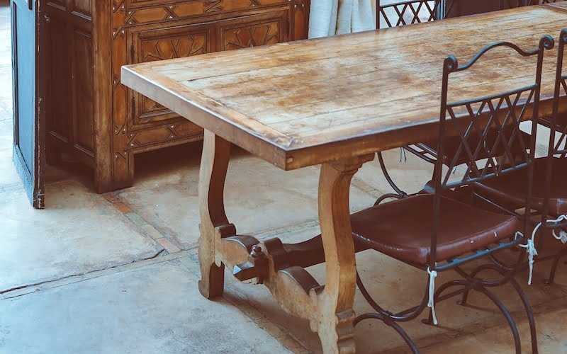 rectangular brown wooden table with chairs